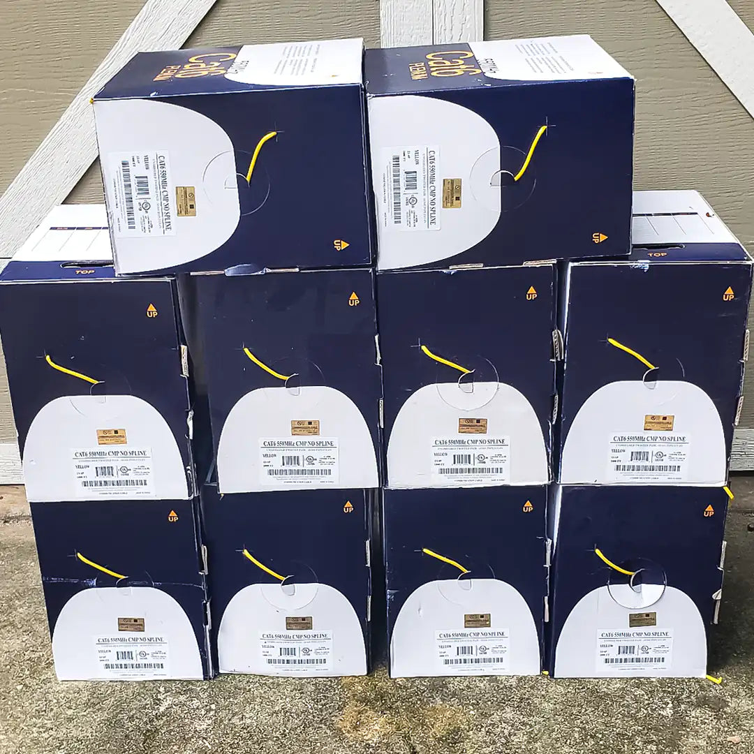 A bulk stack of Wavenet Cat6 Plenum yellow cable pull boxes