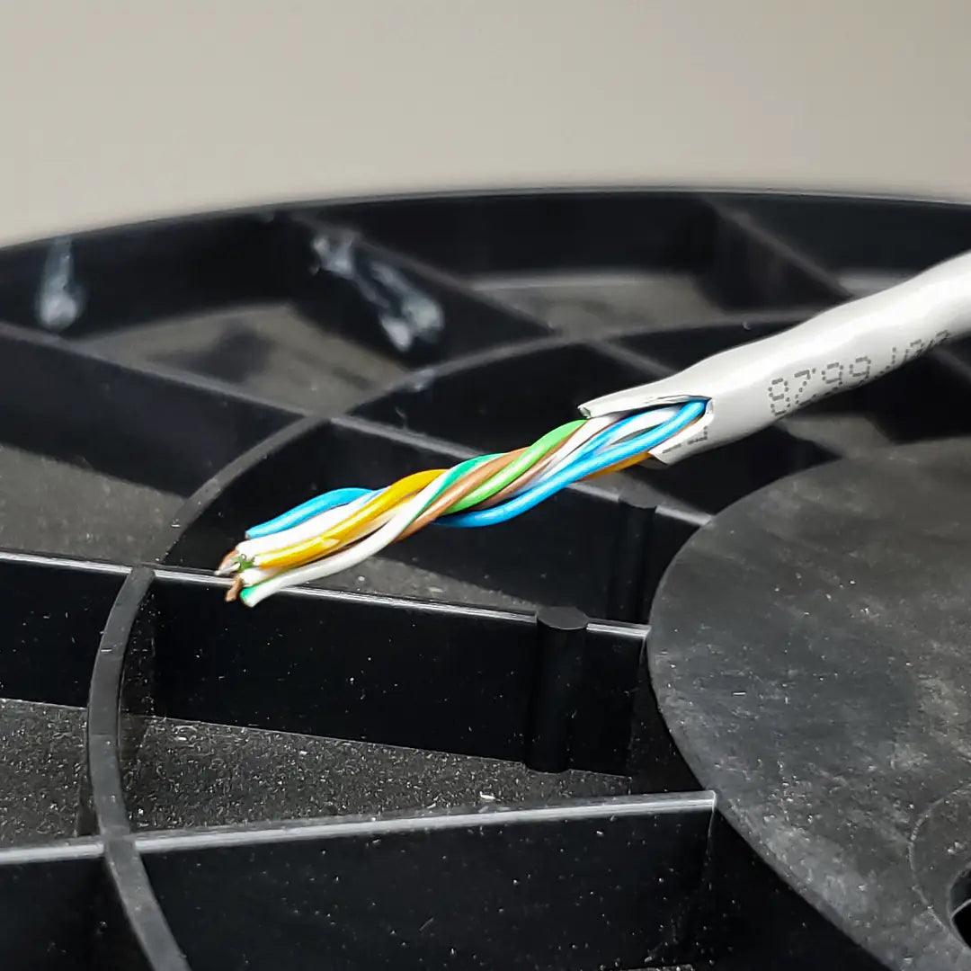 A close-up showing the four internal twisted pairs of the grey Quabbin Cat6 cable