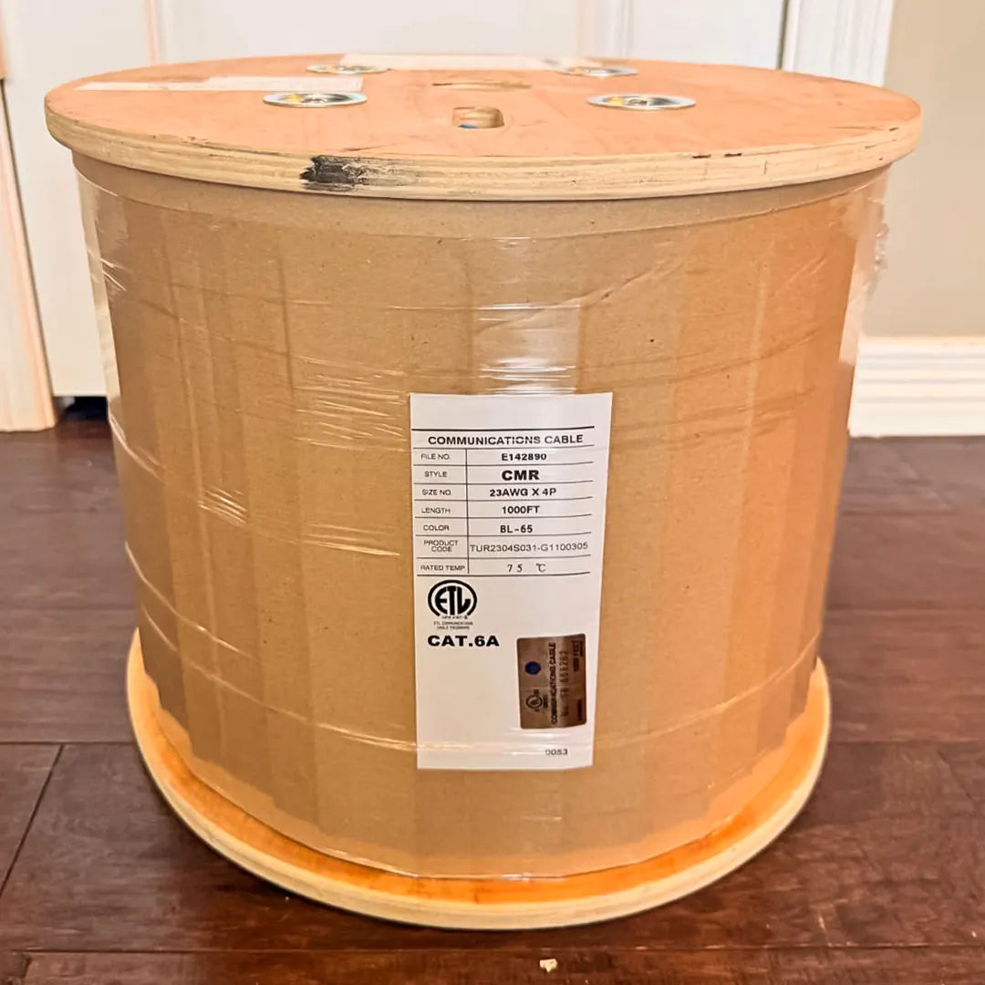 A 1000ft spool of Cat6A Riser blue cable, showing the CMR specification label