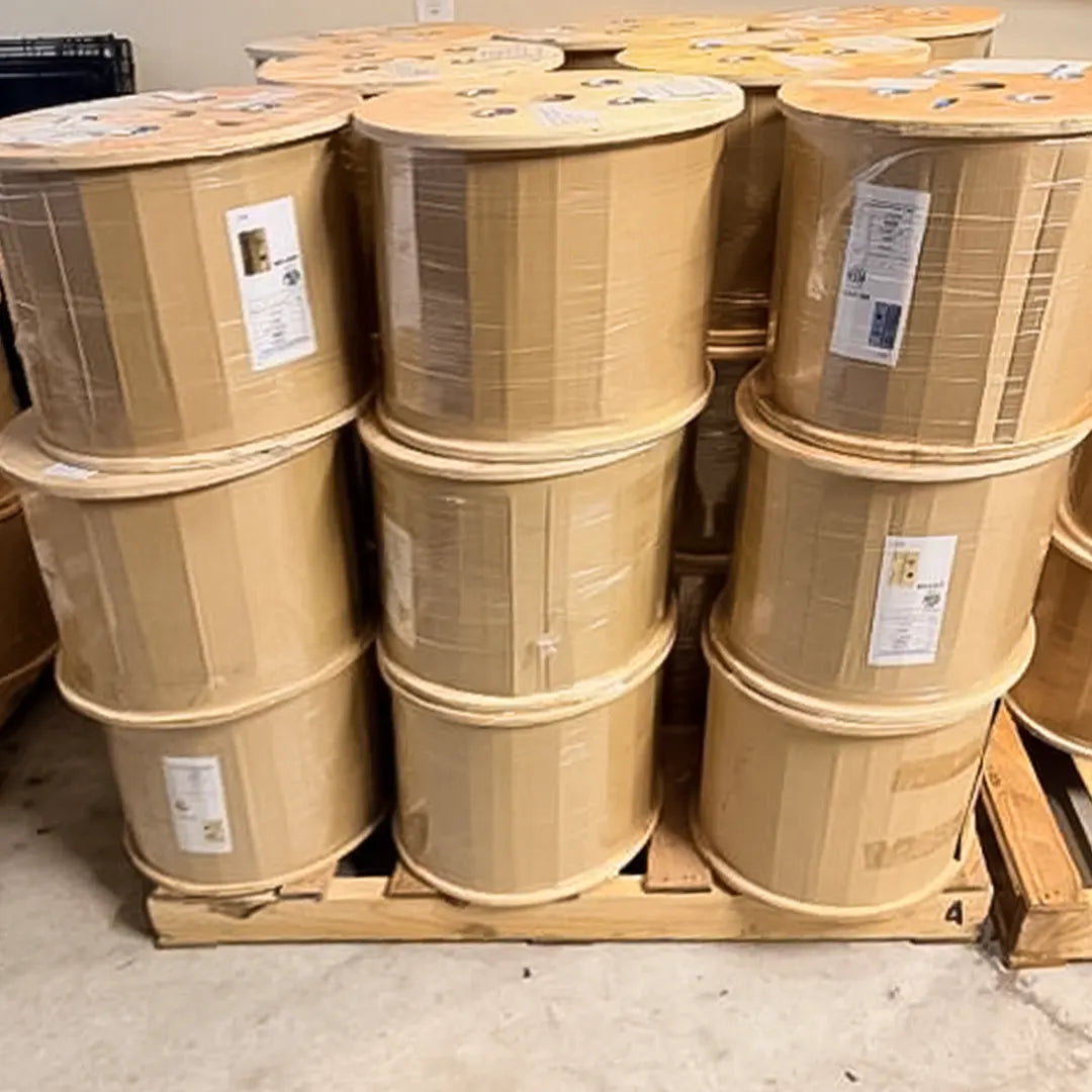 A bulk pallet stacked with spools of 1000ft Cat6A Riser CMR cable