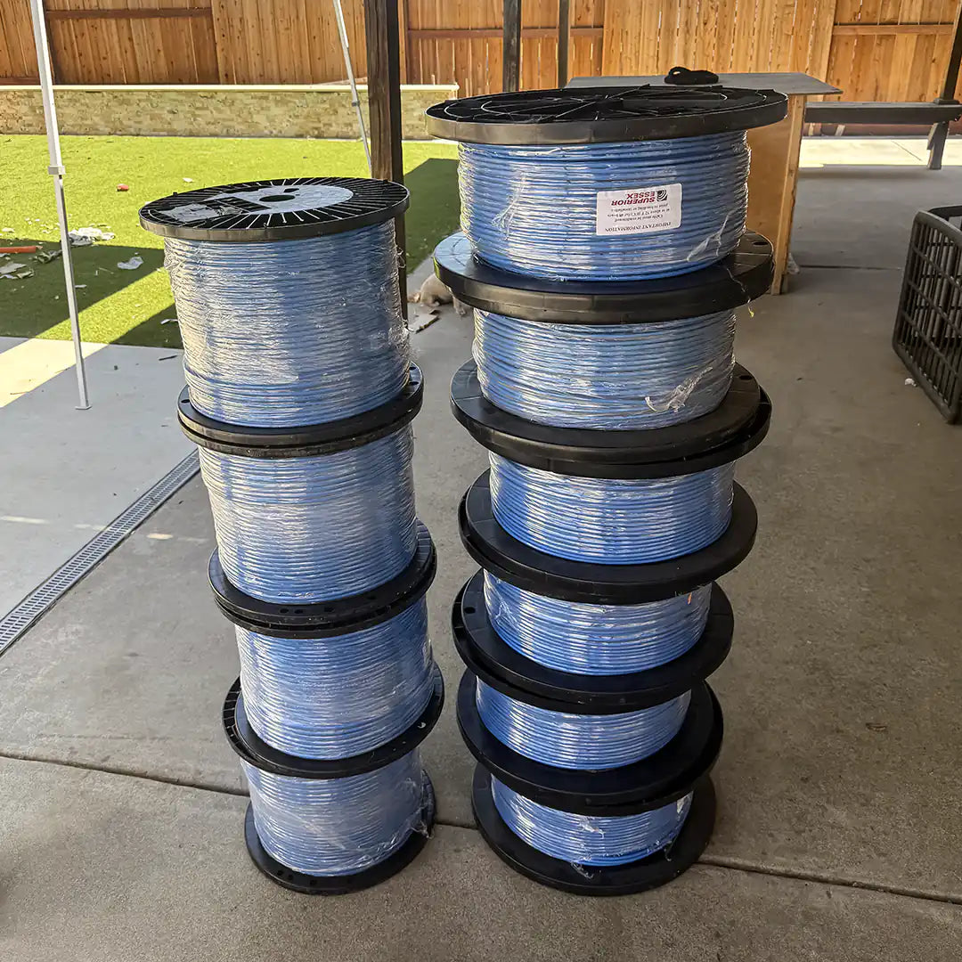 Two tall stacks of Superior Essex Cat6A 10Gain XP+ blue cable spools