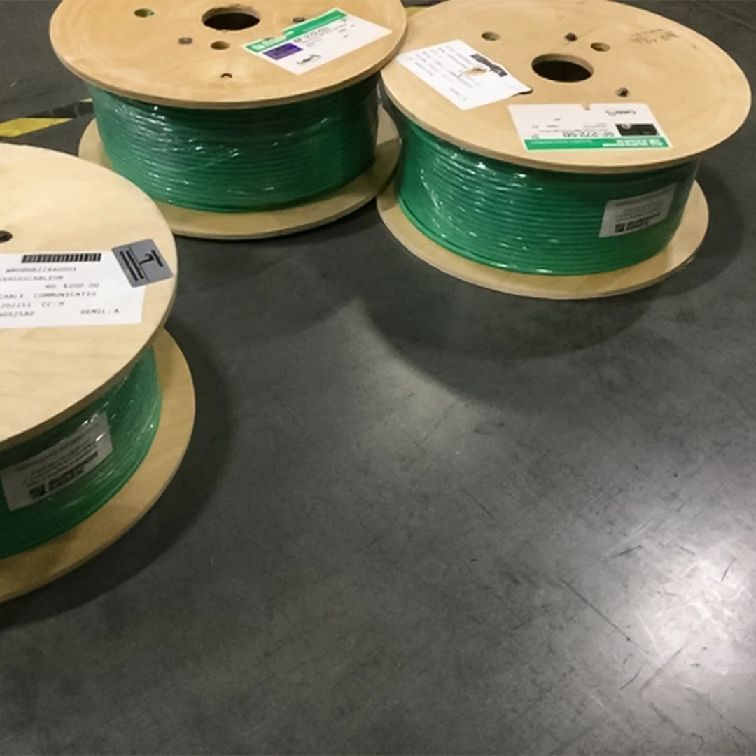 Multiple spools of Superior Essex Cat6A green plenum cable in a warehouse