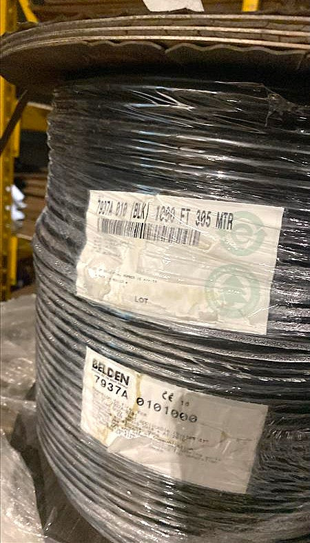 A 1000ft spool of Belden 7937A DataTuff black cable showing the manufacturer's product labels