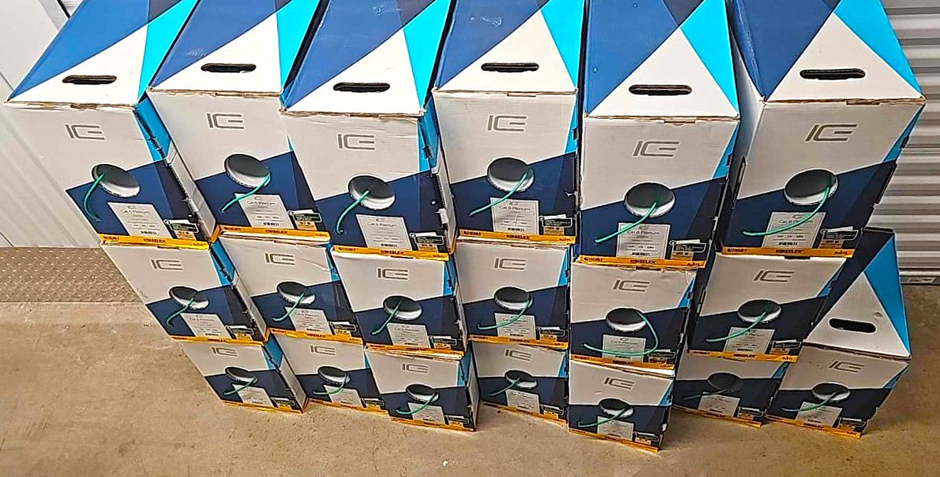 An angled view of a bulk pallet of ICE Cat6 Plenum green cable pull boxes