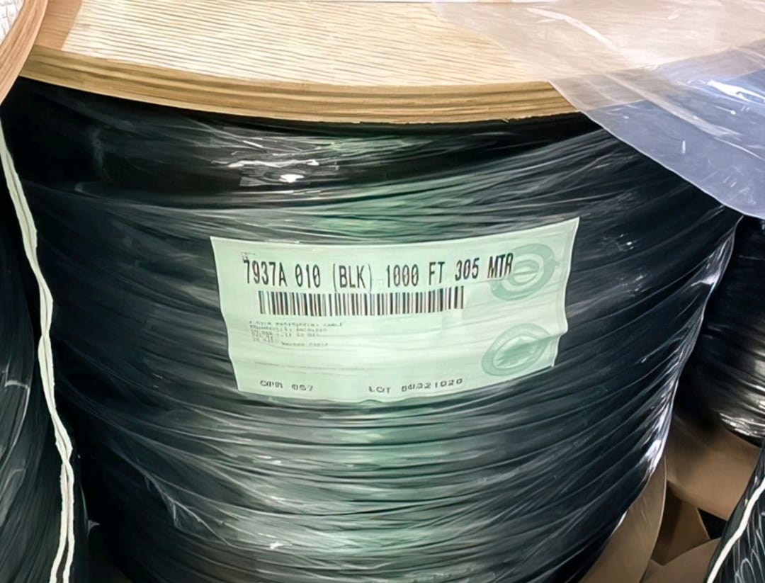 A close-up of the product label on a 1000ft spool of Belden 7937A black OSP burial cable
