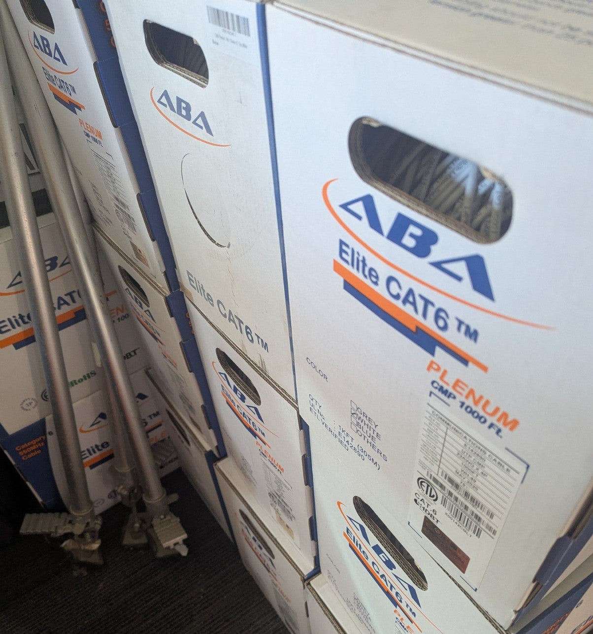 Multiple boxes of ABA Elite CAT6 550MHz Plenum cable stacked, showing the front and side panel designs.