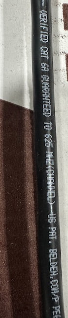 A close-up of the 'CMP' plenum safety rating printed on the Belden cable jacket